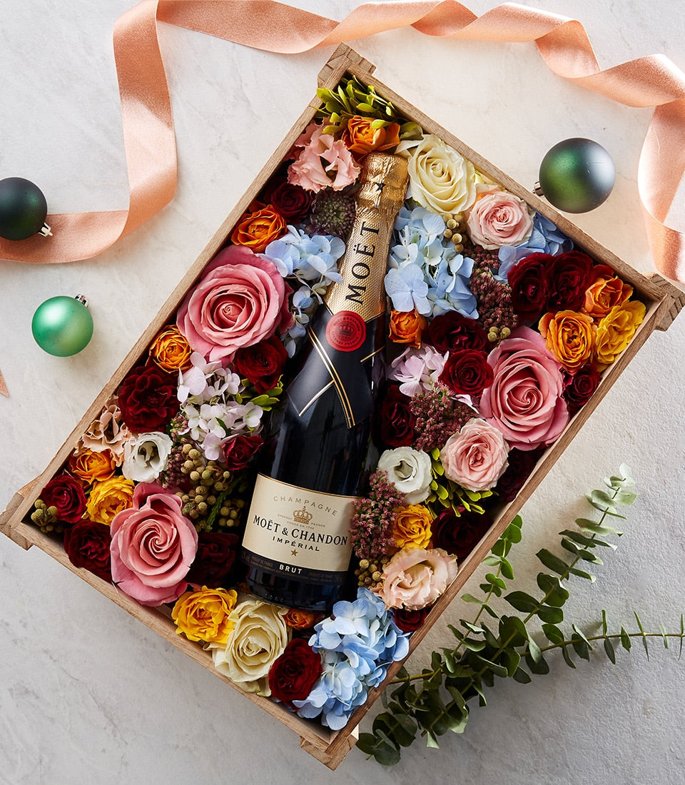 Moët & Chandon champagne with pink roses, hydrangeas, and mixed flowers in wooden gift box