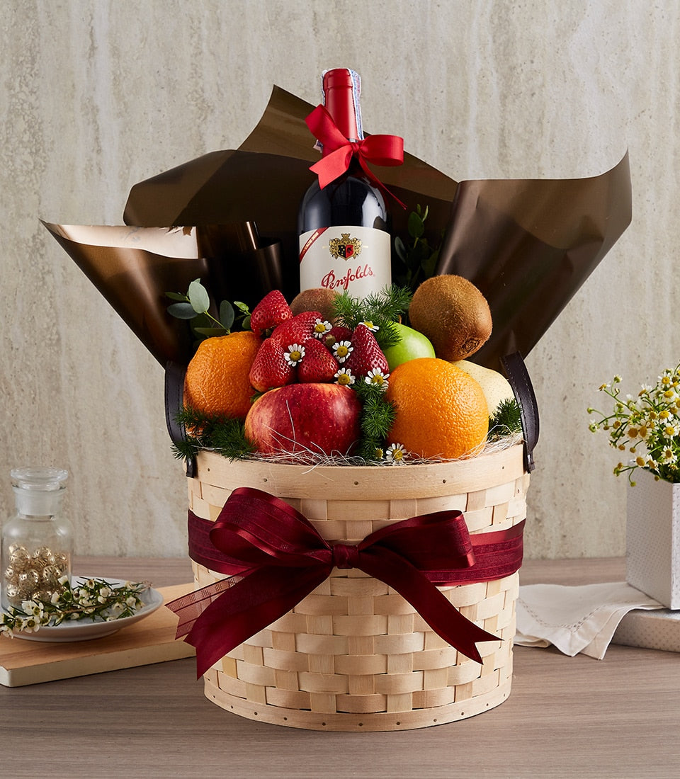 Premium wine and fresh fruit gift basket with red ribbon bow and seasonal produce