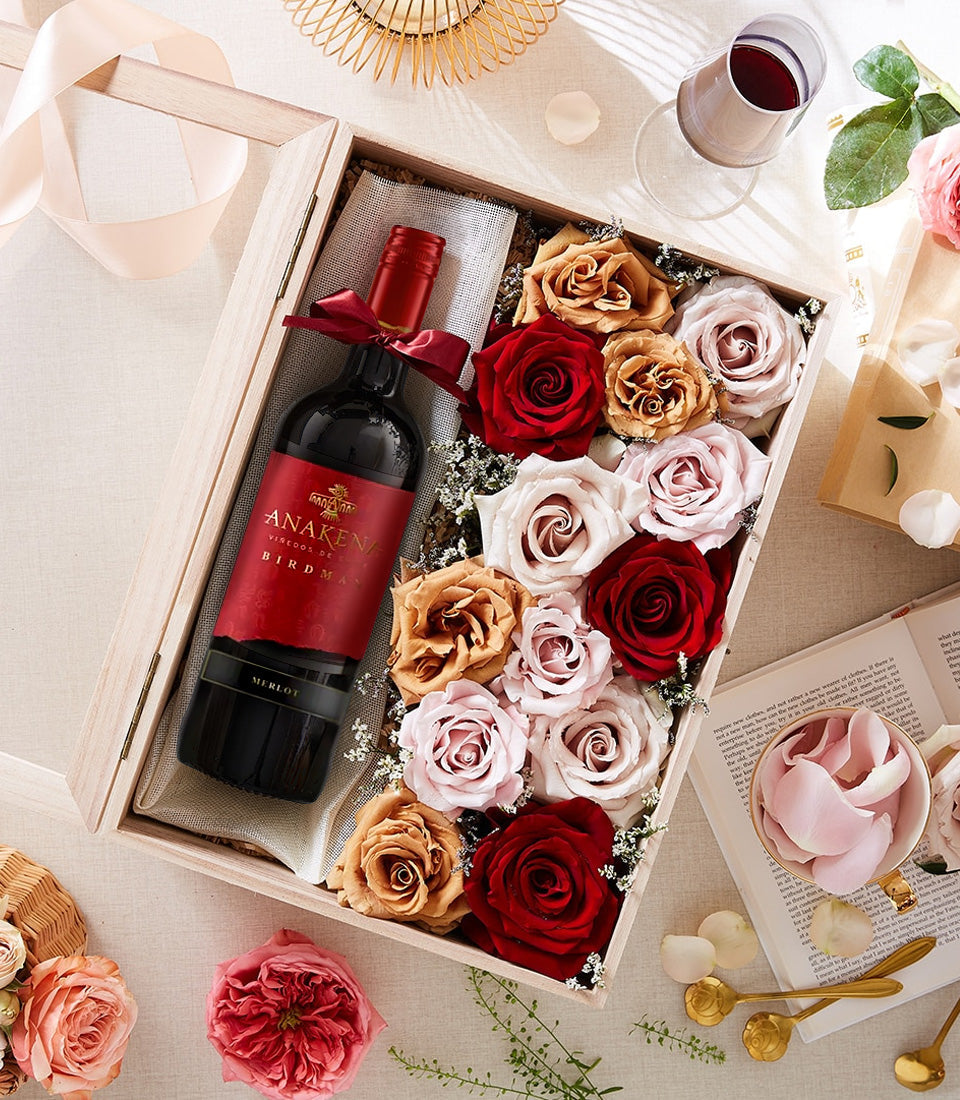 Premium red wine and rose gift box set for anniversaries, featuring Anakena Merlot with deep red and blush artificial roses