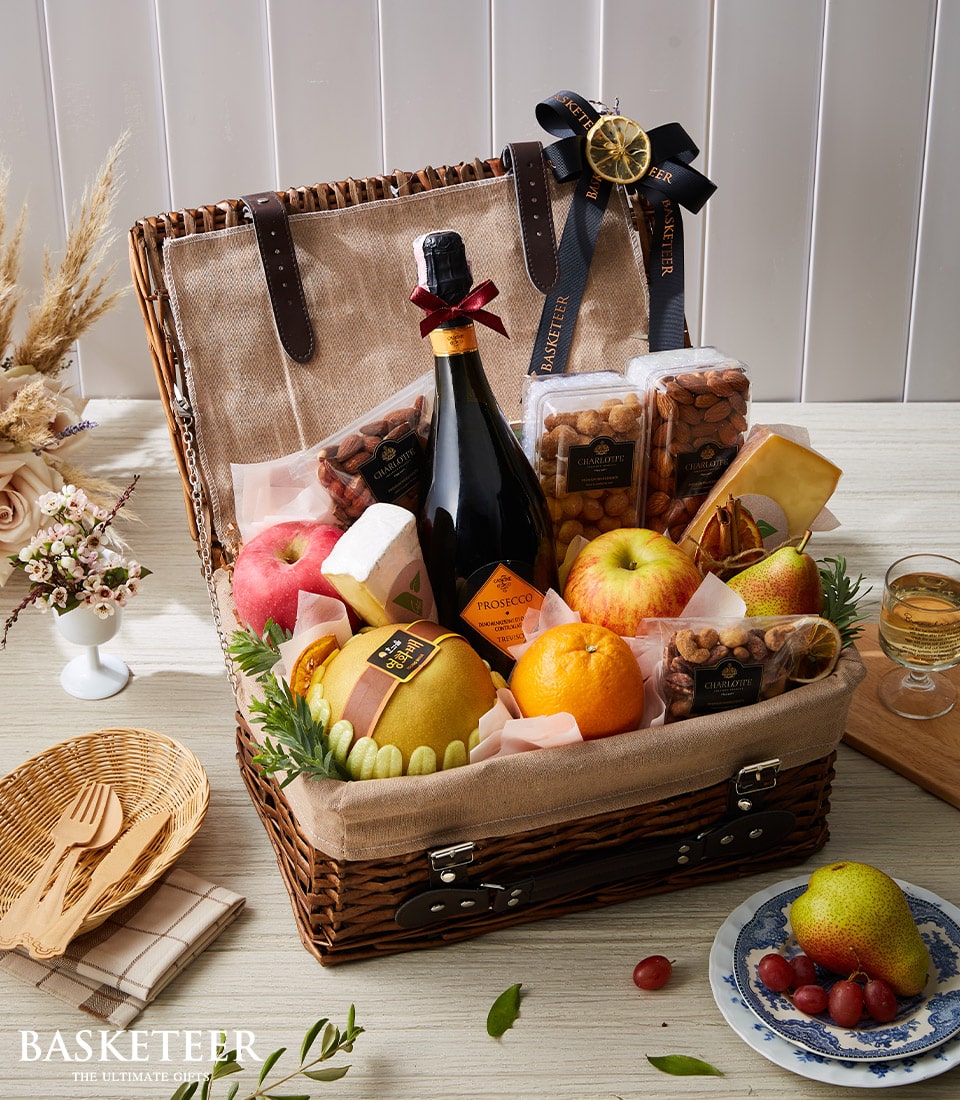 Prosecco and premium fruit cheese hamper with wicker basket, sparkling wine, artisan cheeses, and fresh fruit