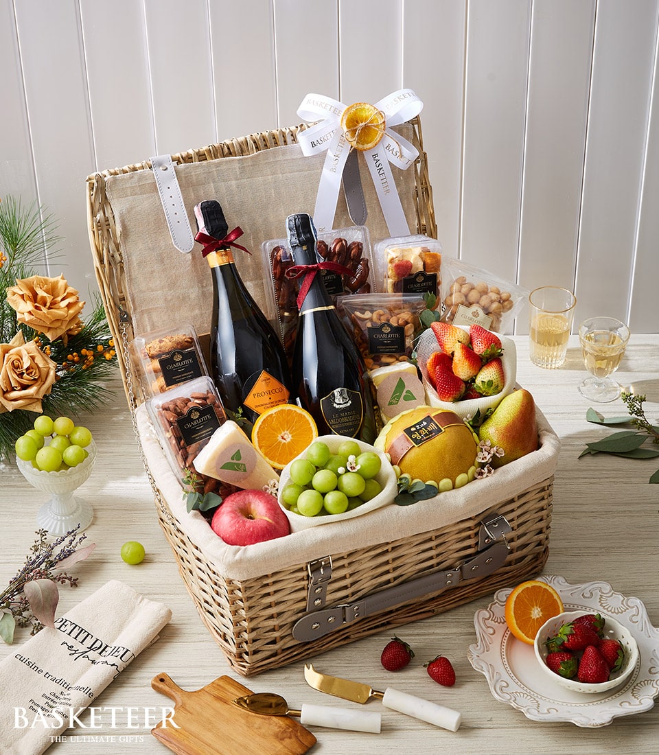 Luxury wicker hamper with twin bottles of Prosecco, fresh fruit, gourmet nuts, cheese and artisan treats in cream linen