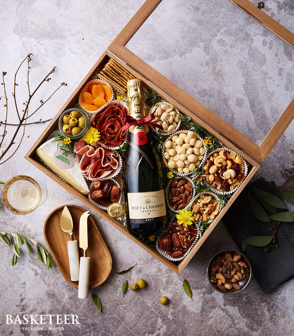 Moët & Chandon champagne hamper with gourmet cheese, nuts, cured meats, and crackers in wooden gift box