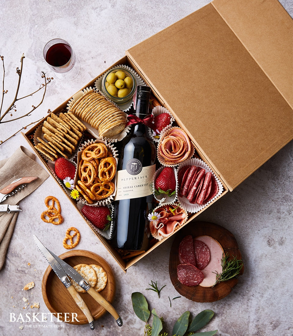 Pepperjack Shiraz wine gift box with gourmet charcuterie, crackers, olives, and cured meats in premium hamper