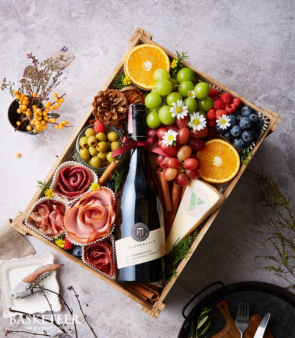 Premium cheese and charcuterie hamper with Chardonnay wine in rustic wooden crate