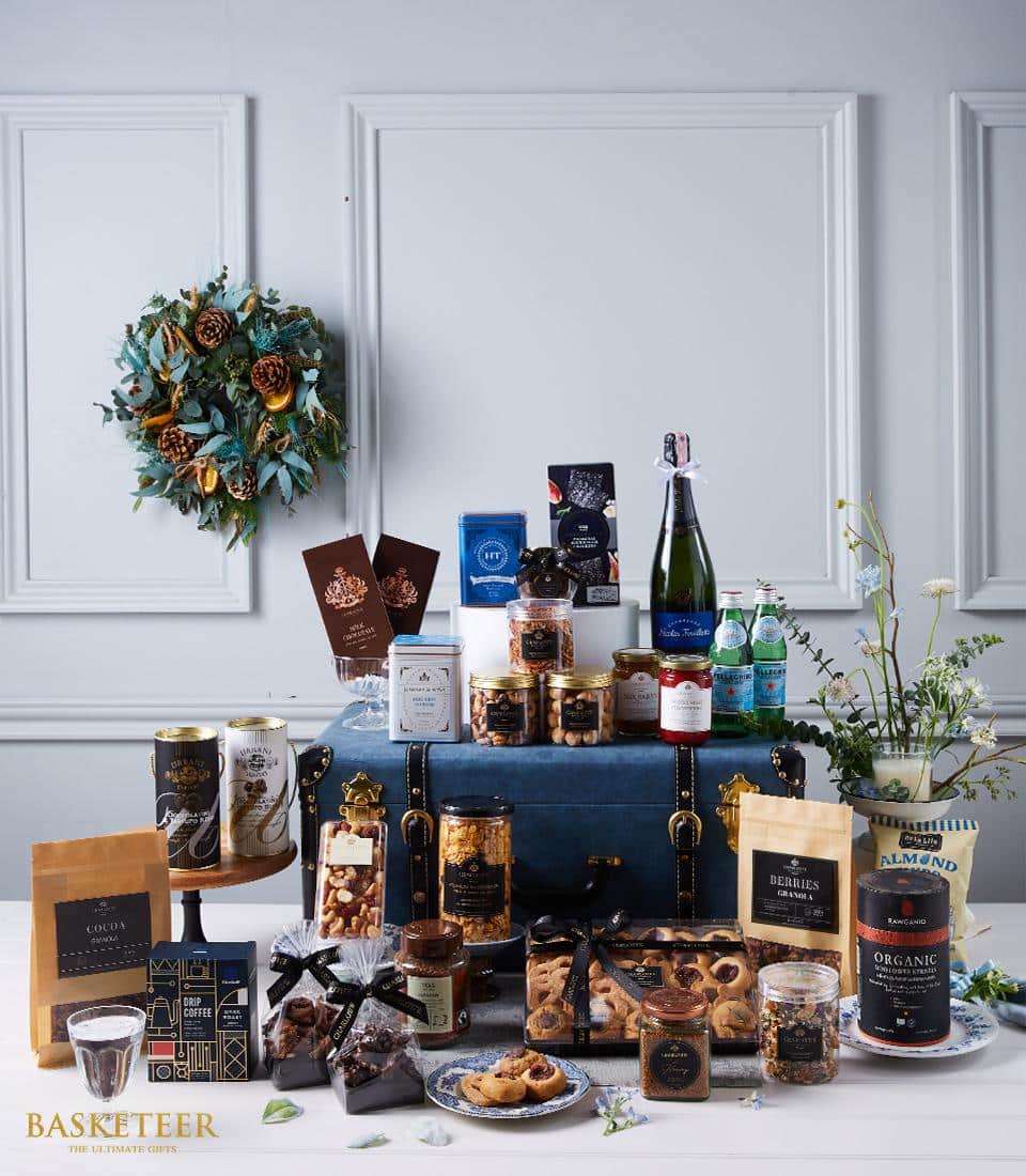 Premium wine and gourmet gift hamper with sparkling wine, artisan chocolates, nuts, and specialty foods in luxury