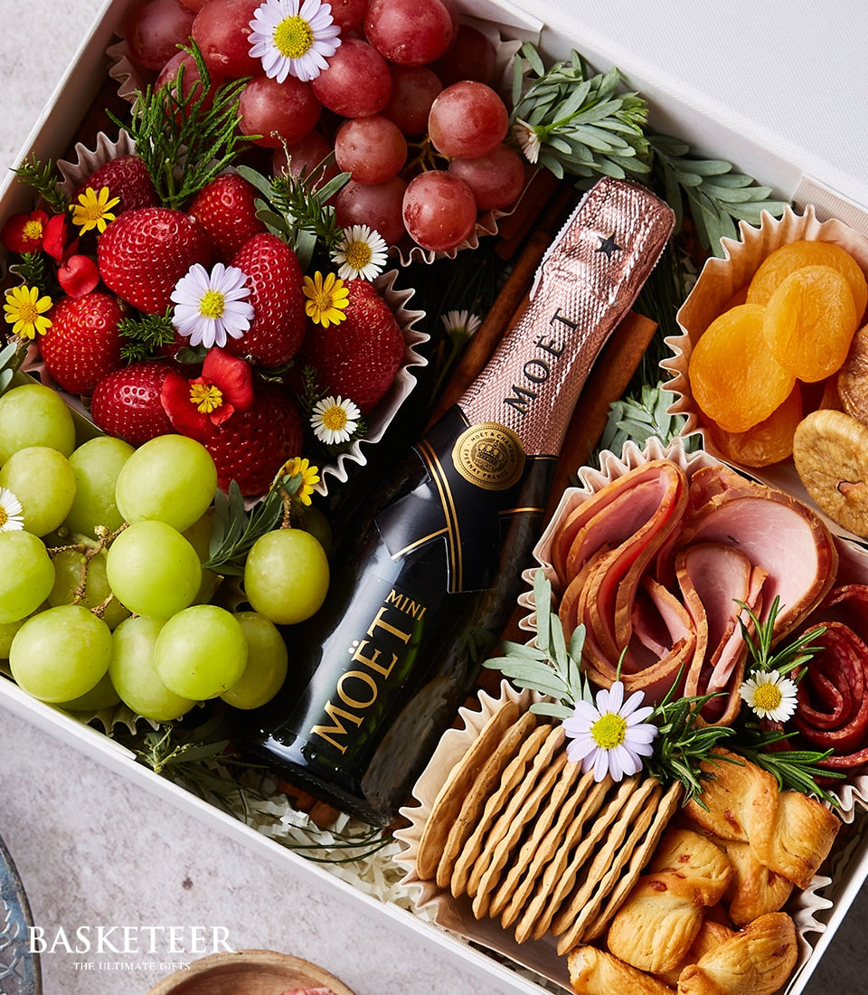 Moët Rosé mini champagne with fresh fruit, cured meats, and artisan crackers in luxury gift box