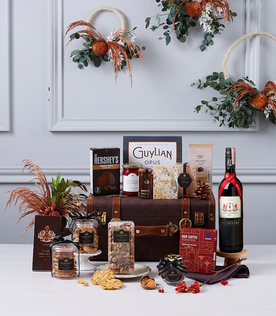 Premium luxury wine hamper with gourmet chocolates, preserves, and artisan treats in leather trunk