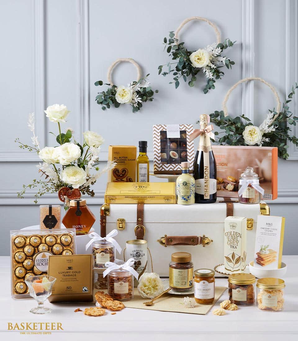 Premium champagne hamper with gourmet chocolates, honey, and preserves in luxury leather trunk