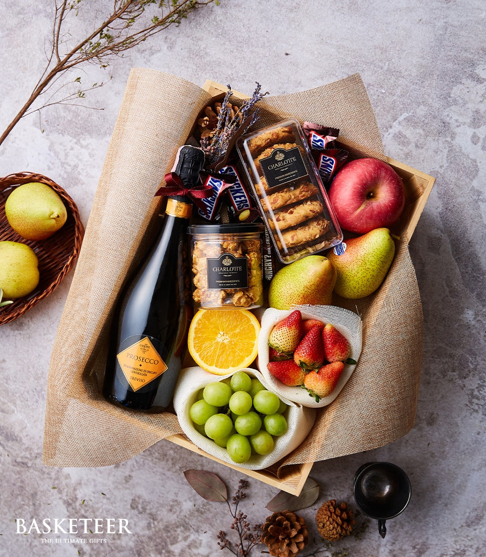 Prosecco sparkling wine gift basket with fresh fruit, artisan cookies, and gourmet treats in wooden crate