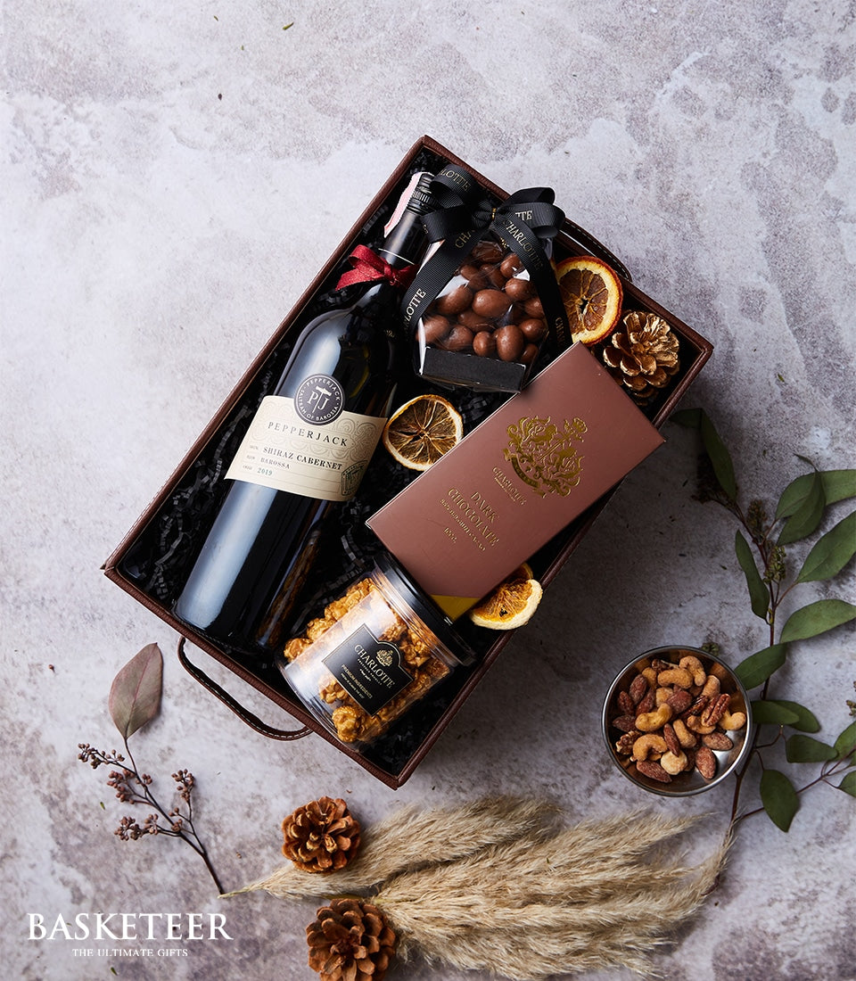 Premium wine and chocolate gift box with Shiraz Cabernet, dark chocolate, and gourmet treats in curated hamper basket