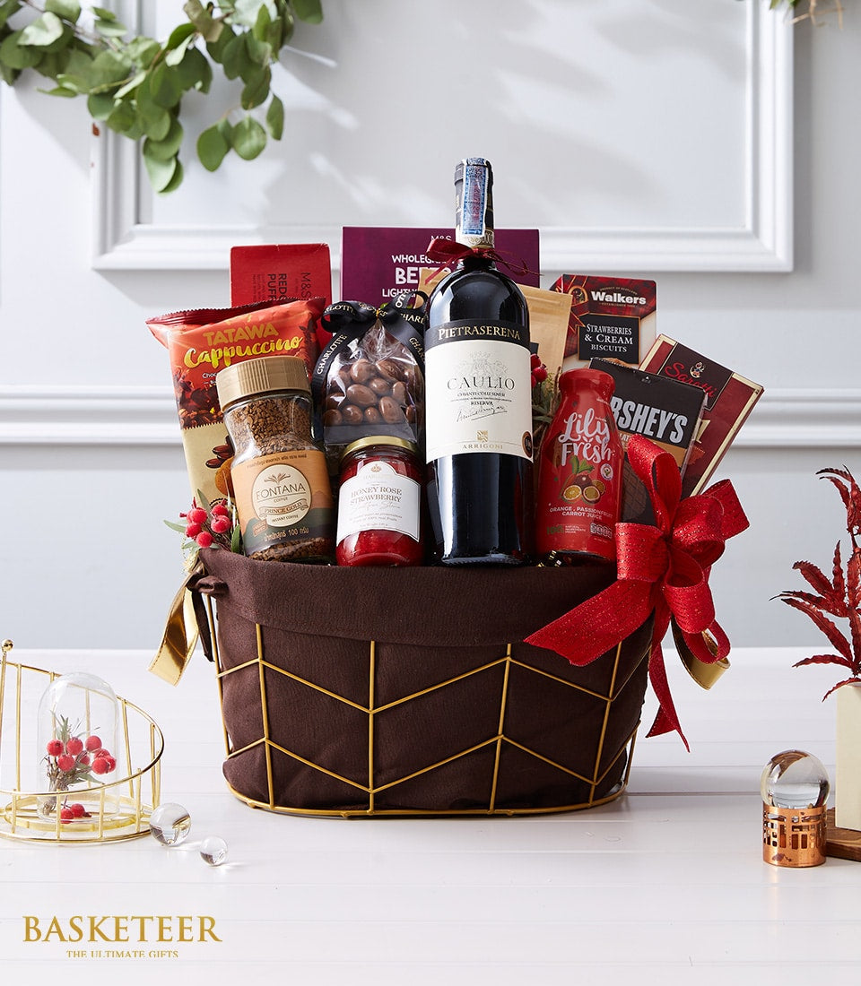 Tuscan wine and gourmet gift basket with dark red wine, artisan coffee, jam, chocolate, and biscuits in gold wire frame