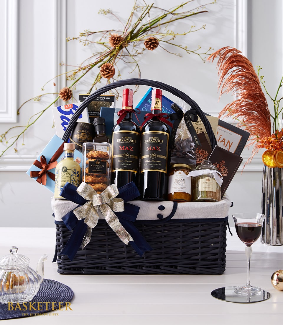 Luxury red wine gift basket with gourmet treats, navy woven hamper with gold ribbon bow