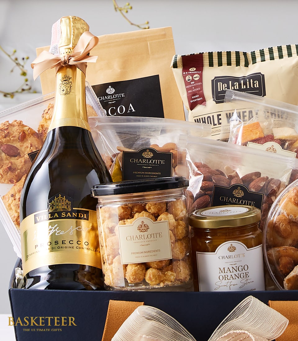 Premium prosecco gift box with gourmet treats, artisan nuts, and Charlotte Bakery snacks in elegant dark blue packaging