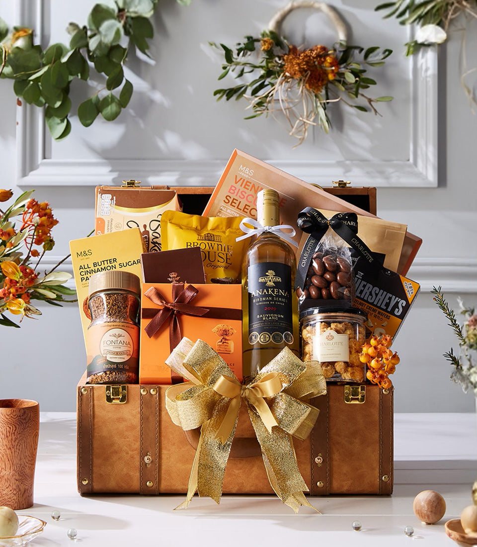 Luxury white wine gift hamper in leather-look trunk with gourmet treats, coffee, and chocolate-covered nuts