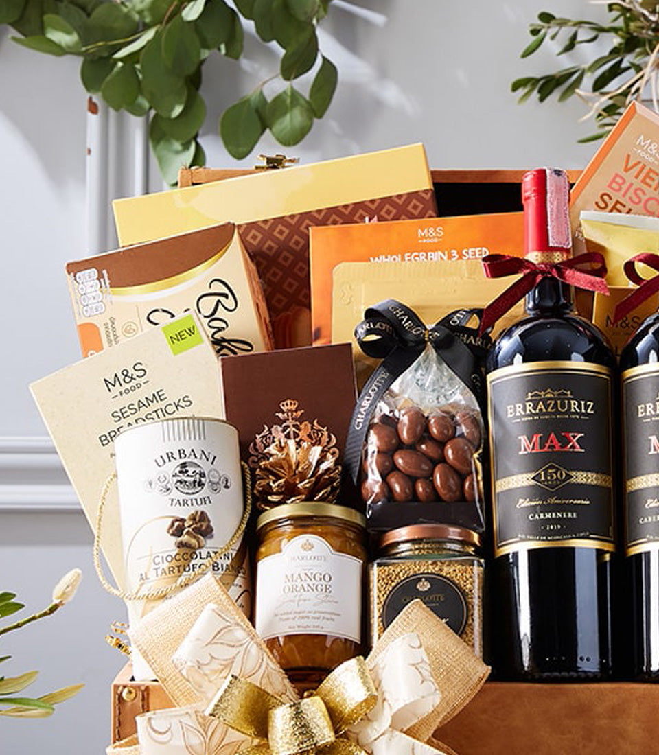 Luxury red wine gift hamper with gourmet chocolates, crackers, preserves, and artisan treats in wooden chest
