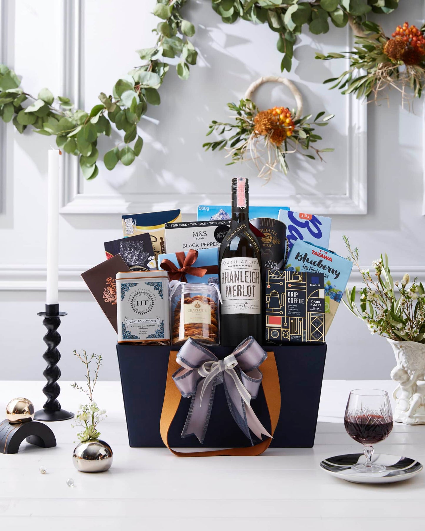 Premium wine hamper with Merlot, gourmet crackers, jam cookies, and specialty coffee in elegant dark blue gift box