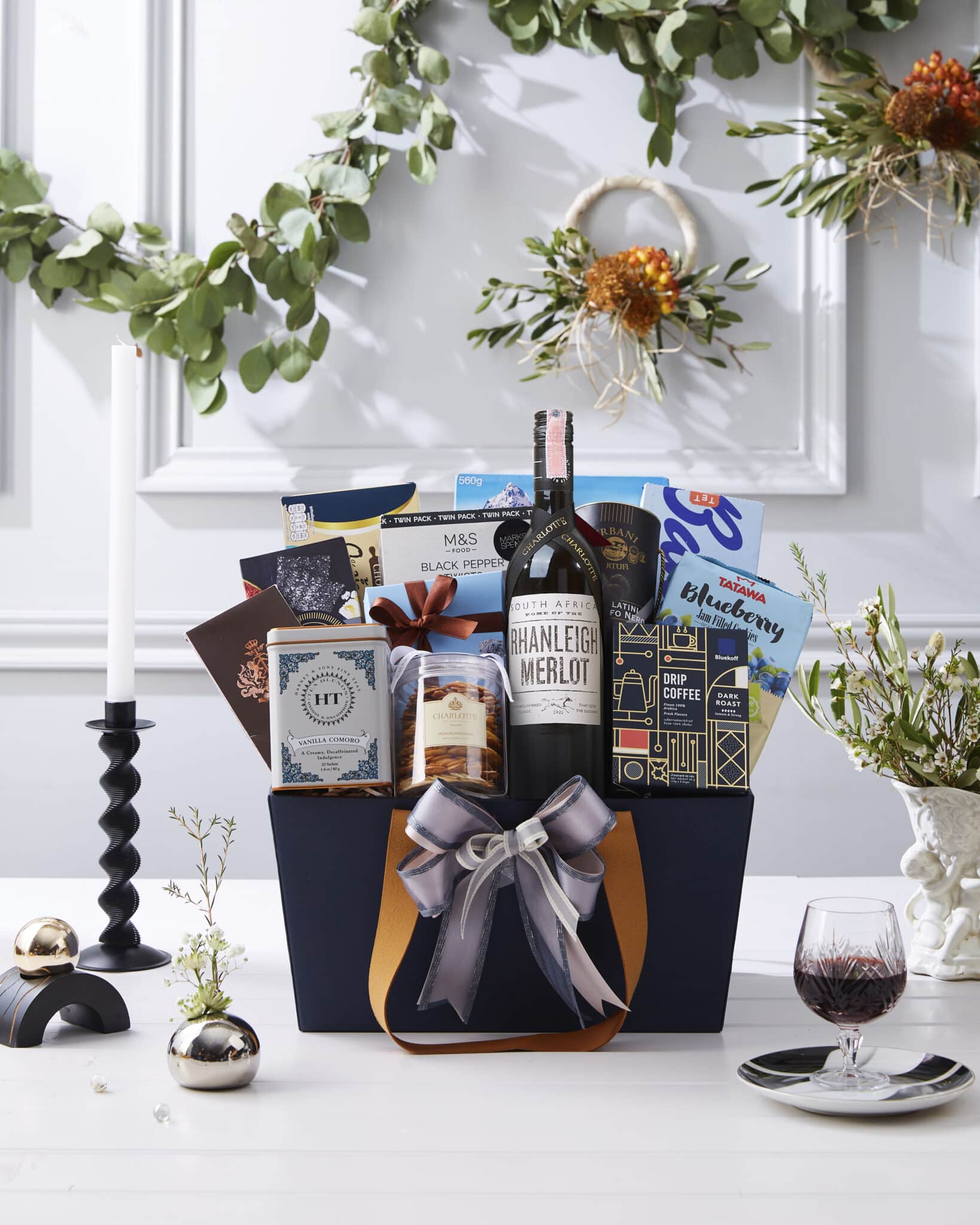 Premium wine hamper with Merlot, gourmet crackers, jam cookies, and specialty coffee in elegant dark blue gift box