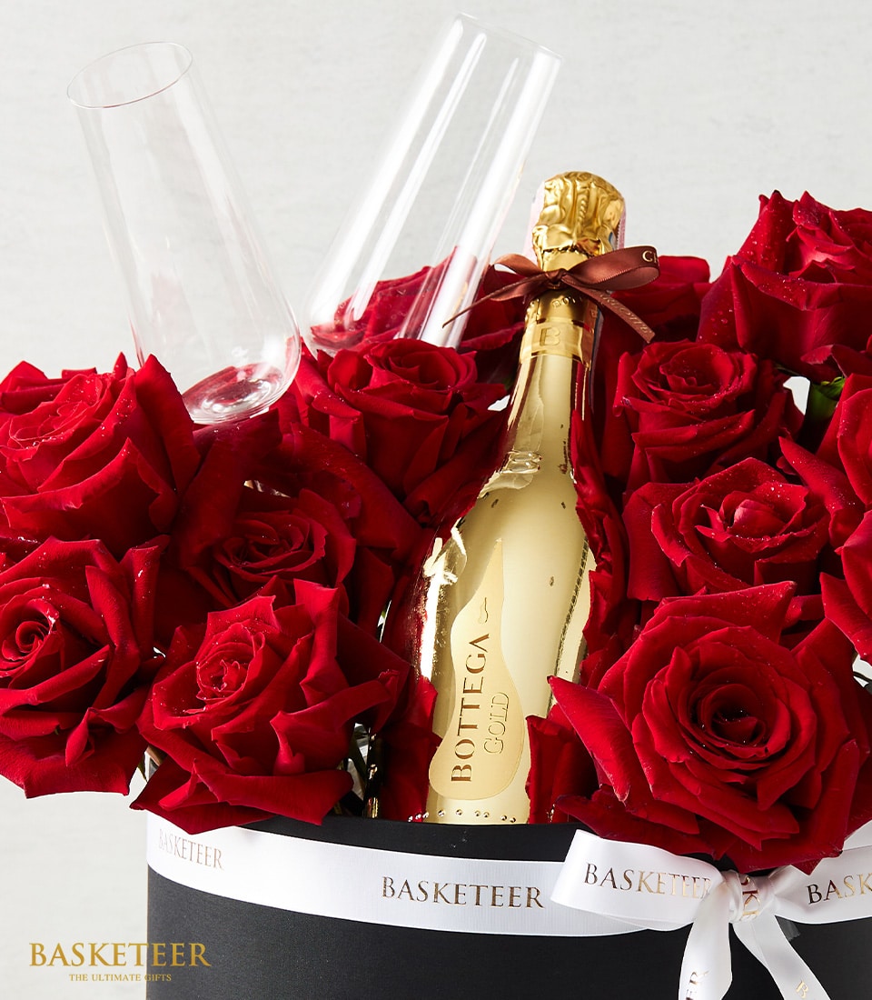 Luxury red rose and sparkling wine anniversary gift set with champagne flutes in black gift box