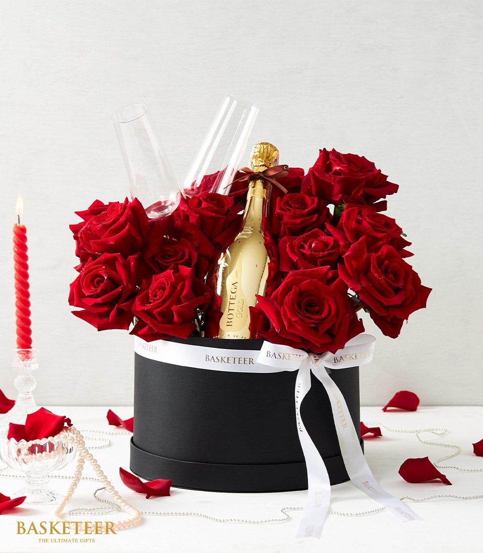 Romantic red rose hatbox with champagne flutes, Bottega Gold sparkling wine, and pearl accents for anniversary celebrations
