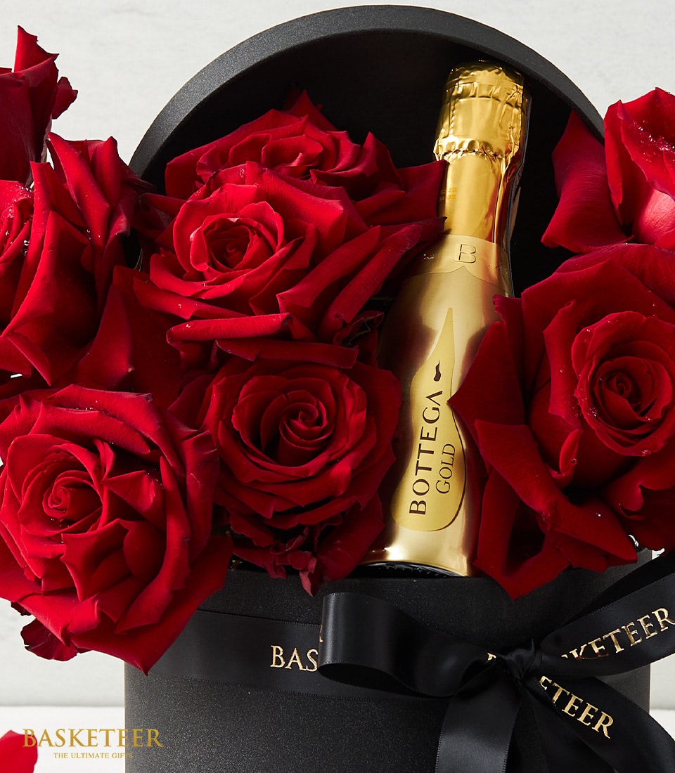 Luxury Valentine's gift box with Ecuadorian red roses and Bottega Gold sparkling wine in black velvet packaging