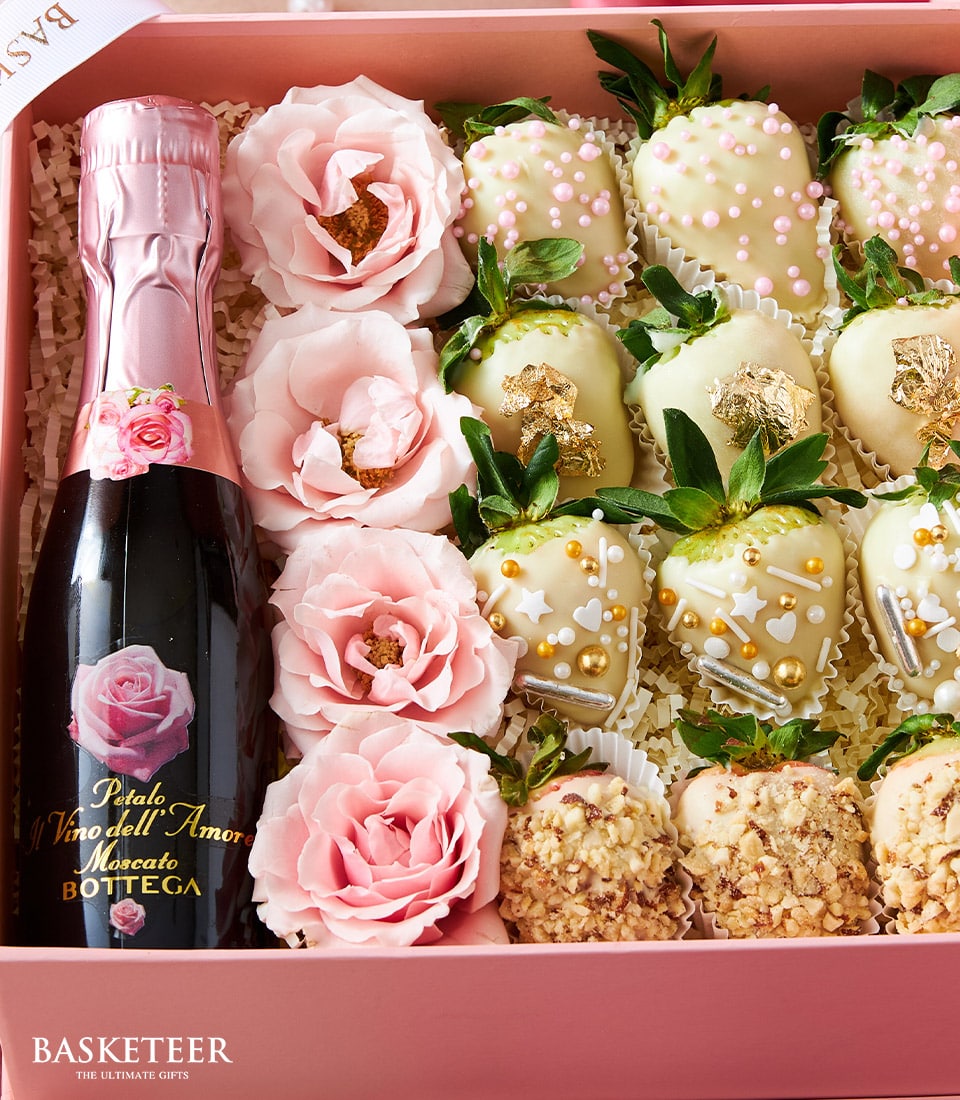 Pink Valentine gift box with sparkling wine, white chocolate strawberries, and pink roses