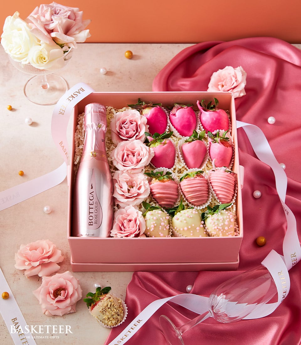 Rosé Gold sparkling wine gift box with chocolate-covered strawberries and pink roses for Valentine's Day