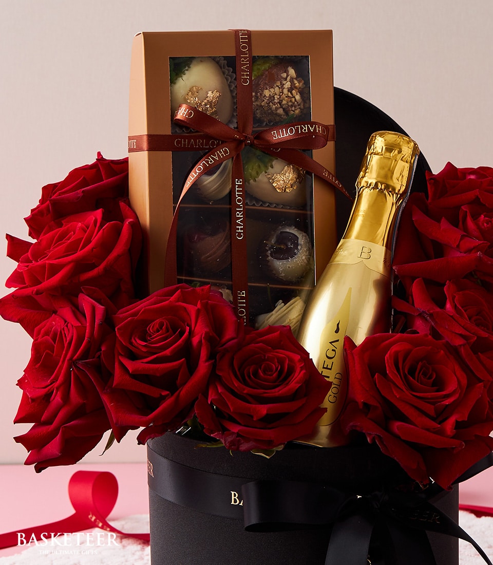 Red roses with champagne and chocolate truffles in luxury black hatbox, Valentine's Day gift set