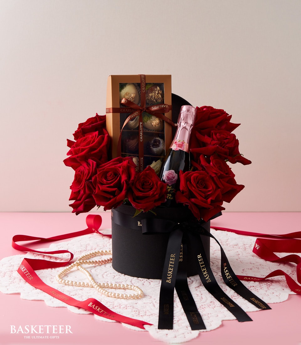 Romantic red roses with pink champagne and chocolate gift box for Valentine's Day