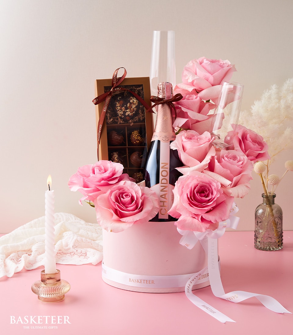 Pink roses, Chandon champagne, and artisan chocolates in luxury gift box for anniversaries