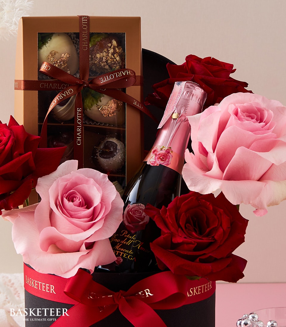 Luxury sparkling wine, artisan chocolates, and Ecuador roses in black gift box, anniversary celebration set