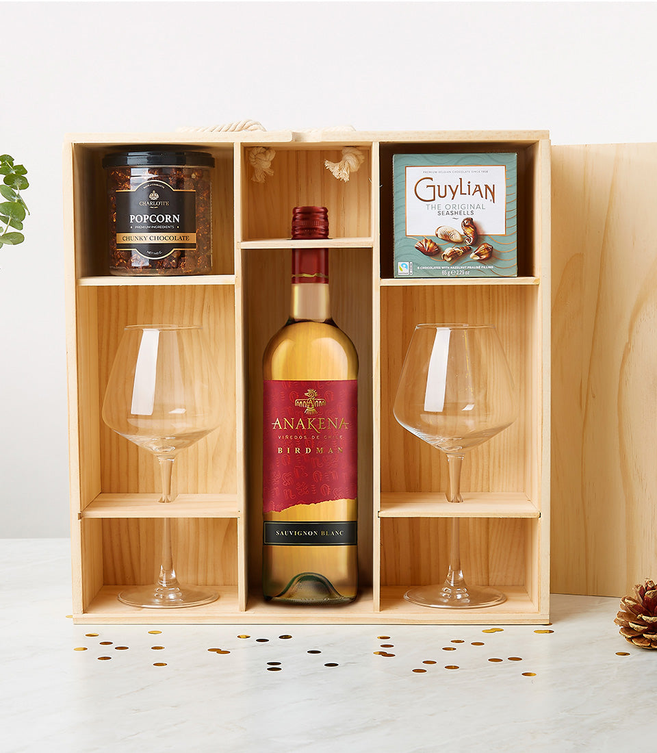 Premium wooden wine gift box with white wine, gourmet chocolates, popcorn, and crystal glasses