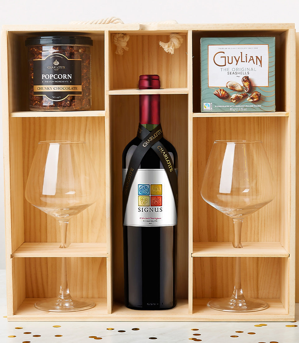 Classy Romance wooden wine crate with red wine, gourmet chocolates, artisan popcorn, and stemmed glasses