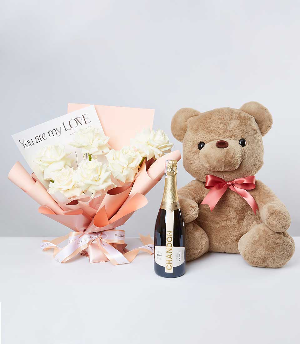 White roses with champagne bottle and teddy bear romantic gift set