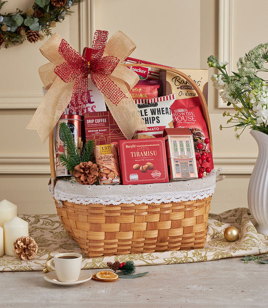 Woven wicker gift basket with gourmet coffee, almond milk chocolate, and artisan snacks tied with red bow