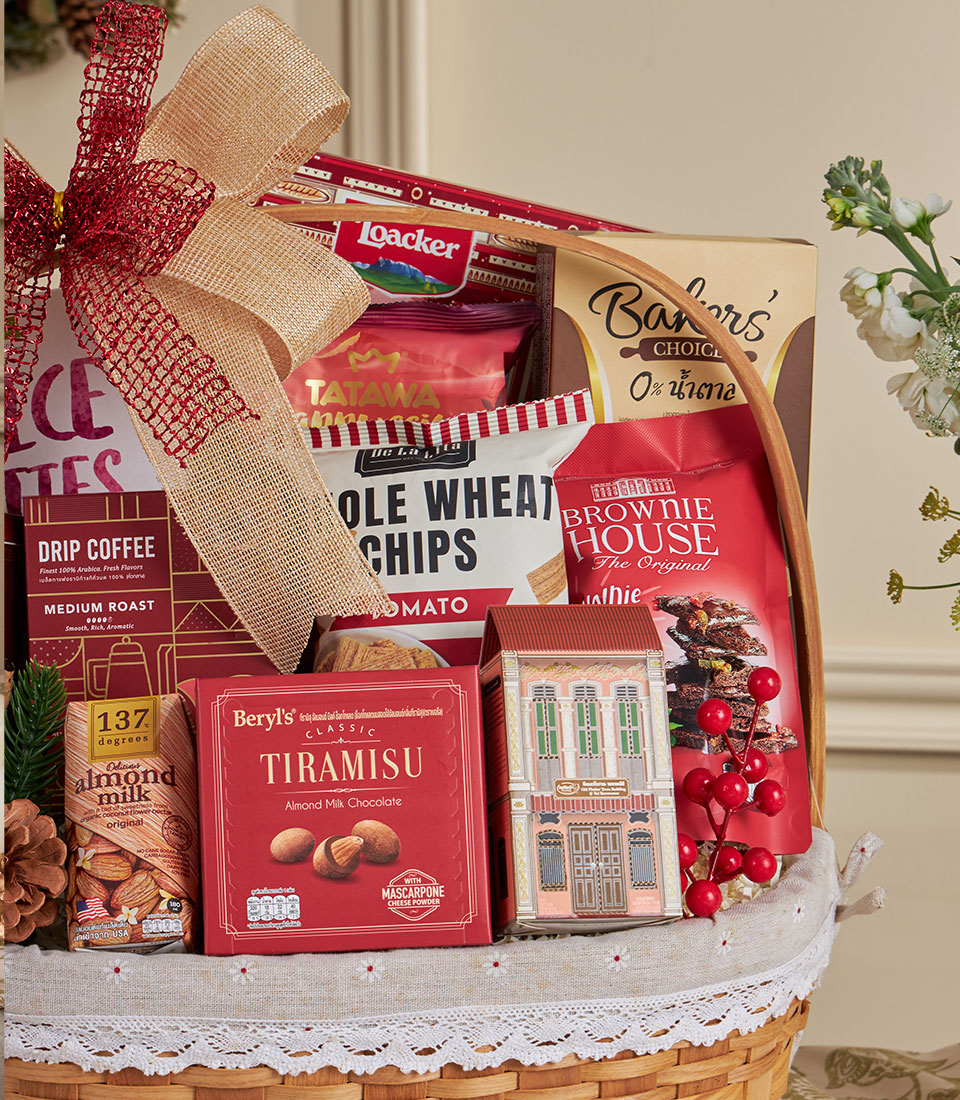 Woven gift basket with red and beige bow, white lace lining, filled with premium coffee, cookies, almond milk, and chocolate