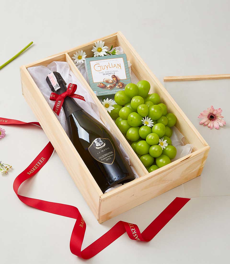 Luxury wooden gift box with Prosecco, Belgian chocolates, and fresh green grapes with flowers