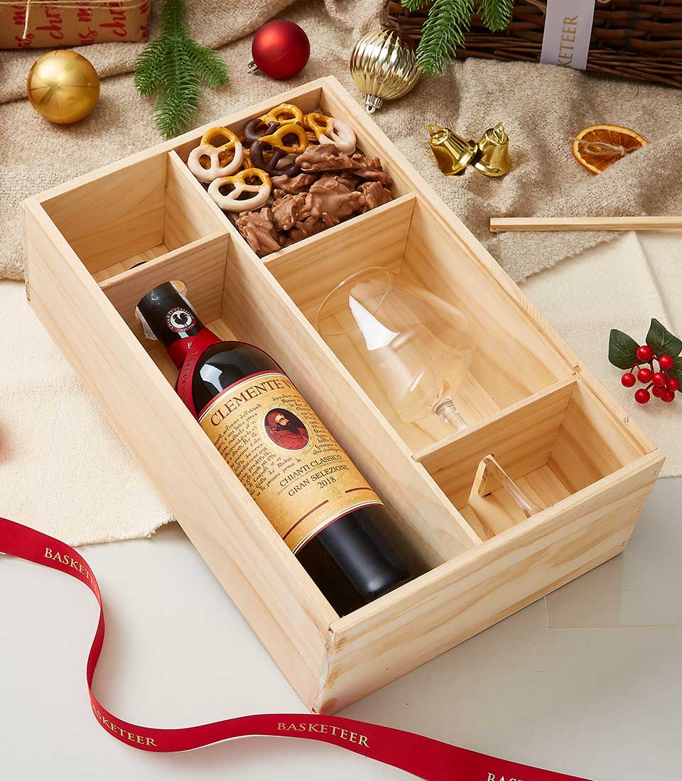 Wooden wine gift box with Clemente Chianti Classico, wine glass, chocolate pretzels, and chocolate-covered nuts