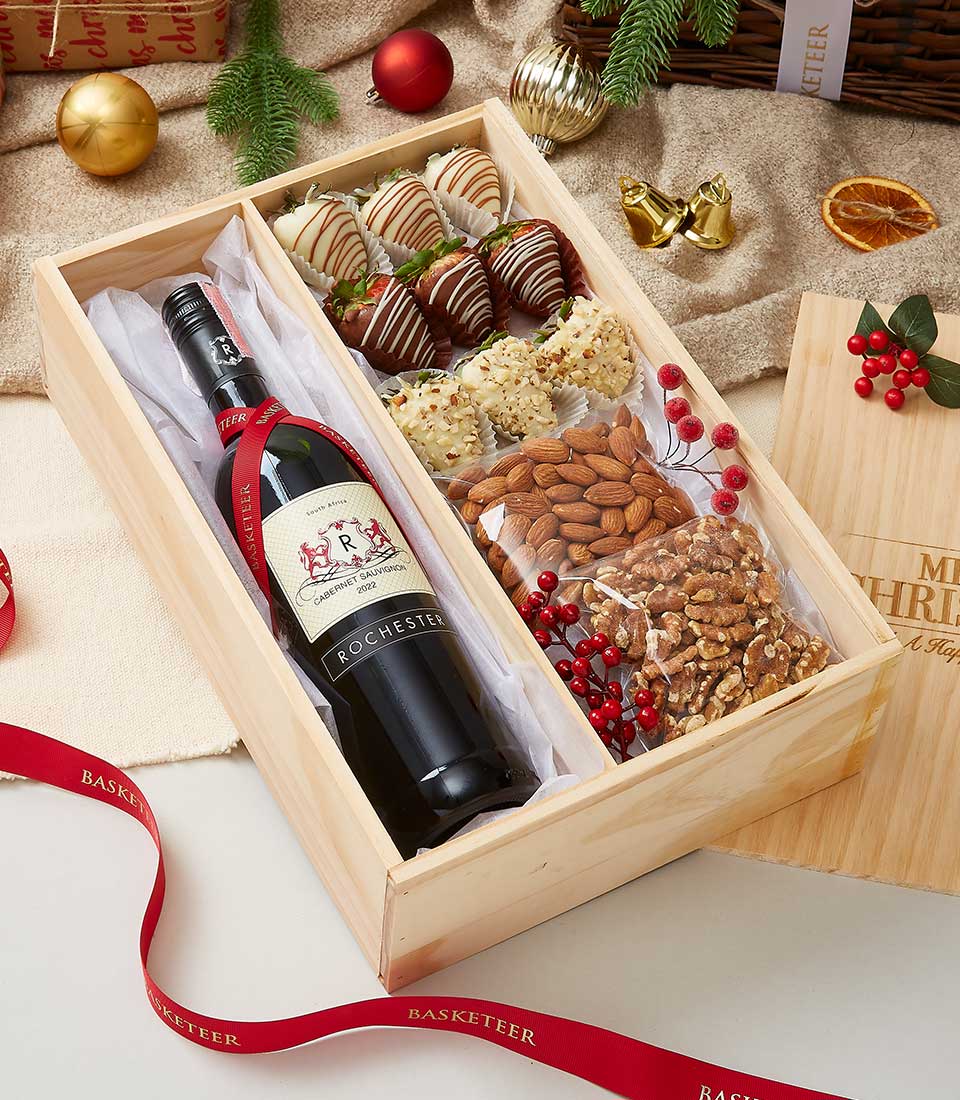 Premium red wine gift box with chocolate-dipped strawberries, nuts, and festive wooden packaging