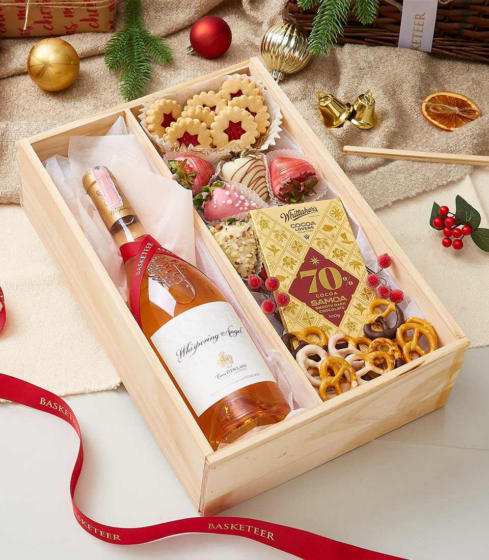 Premium rosé wine and gourmet chocolate gift box with shortbread, chocolate-dipped strawberries, and festive trimmings