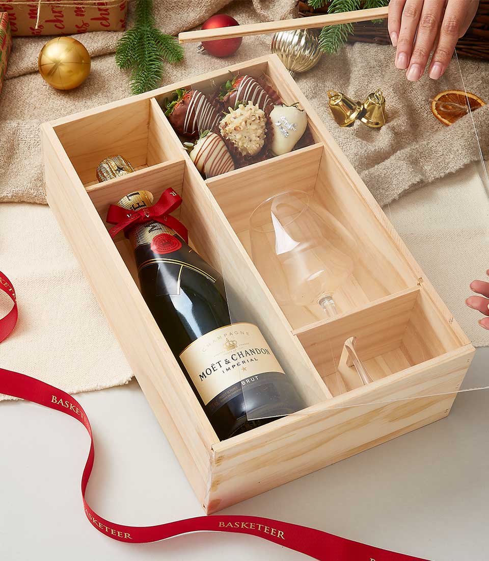 Champagne, chocolate-covered strawberries, and flute in premium wooden Christmas gift box