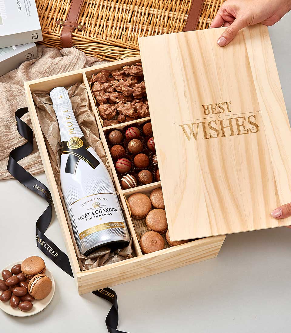 Luxury wooden gift box with Moët & Chandon champagne, chocolate truffles, macarons and gourmet chocolates