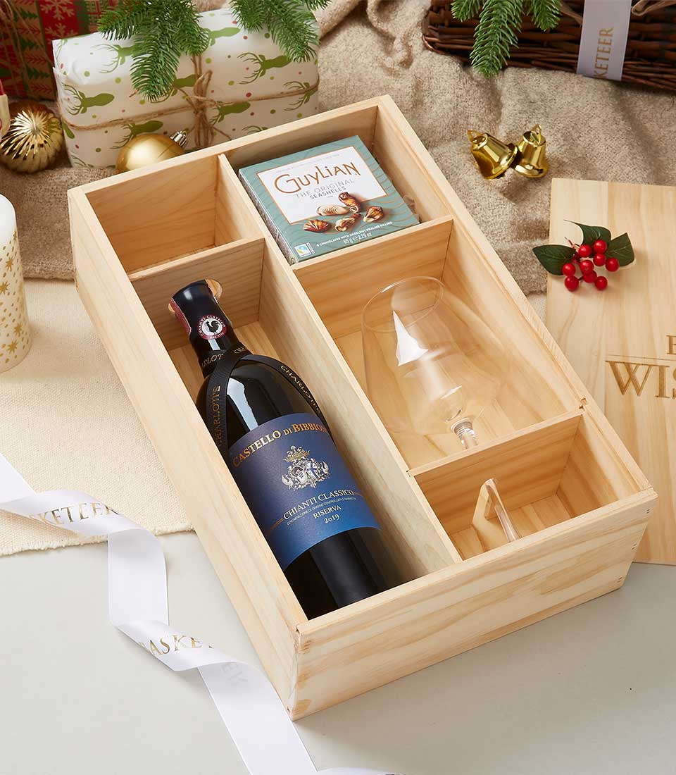 Premium red wine and artisan chocolate in wooden gift box with festive presentation