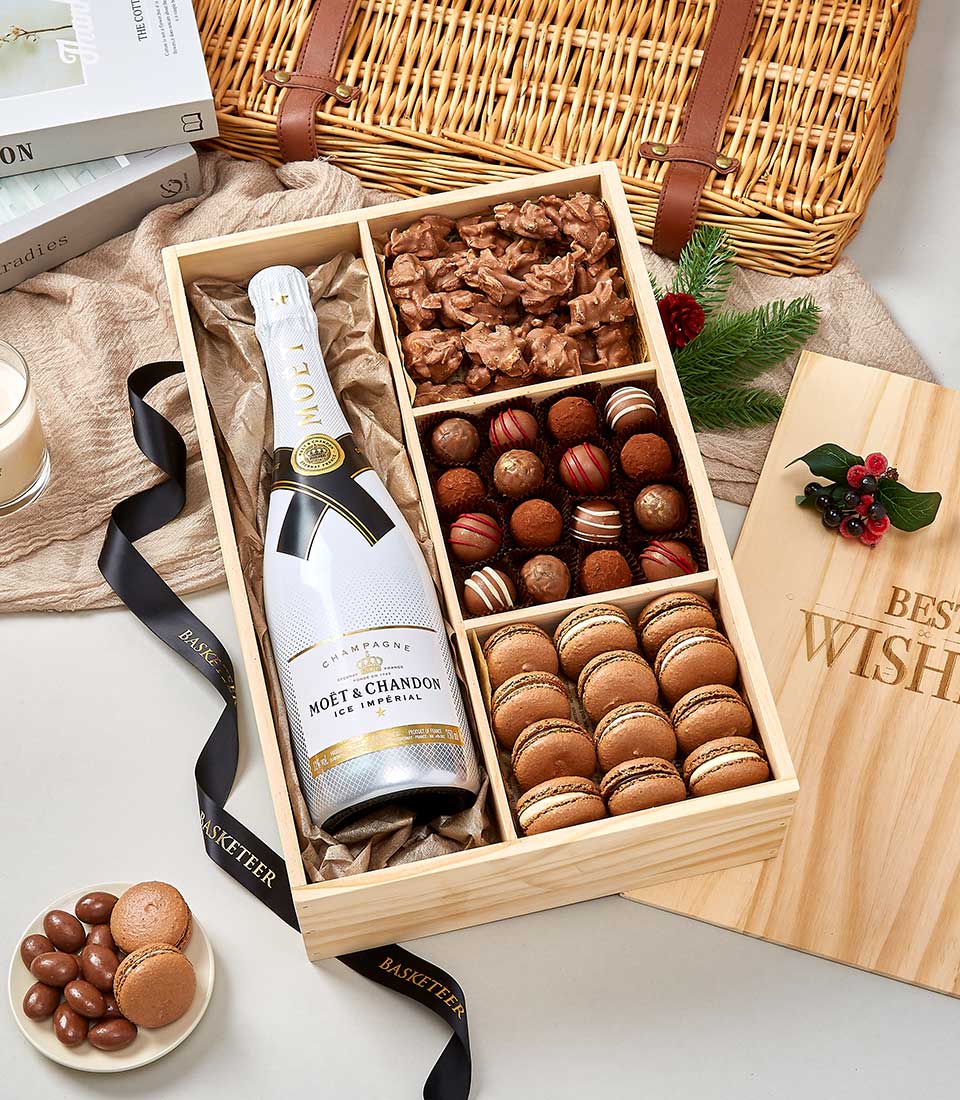 Luxury wooden gift box with Moët & Chandon champagne, chocolate truffles, macarons, and chocolate clusters