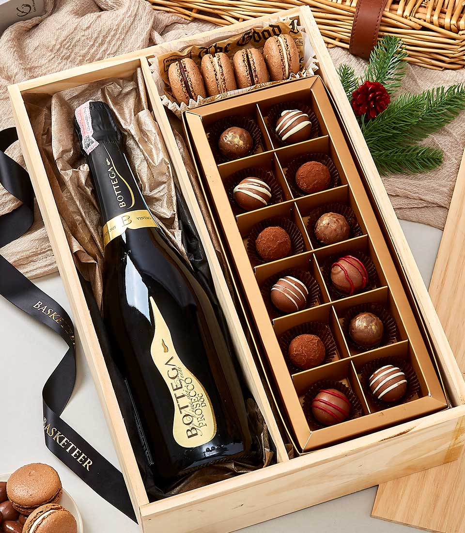 Wooden gift box with Prosecco, chocolate truffles, and macarons for premium wine and chocolate gifting