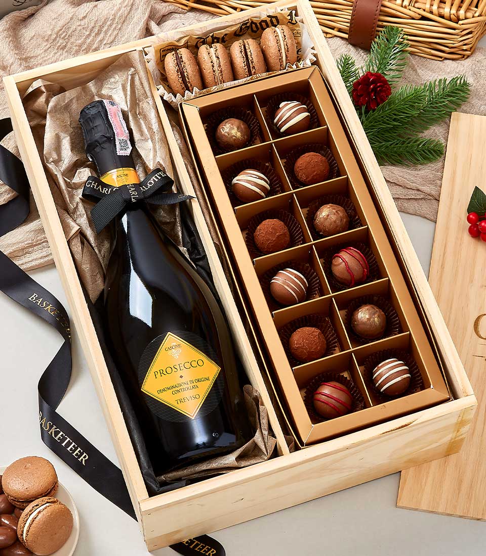 Classic wine and chocolate gift box with Prosecco, artisan truffles, and macarons in natural wood presentation