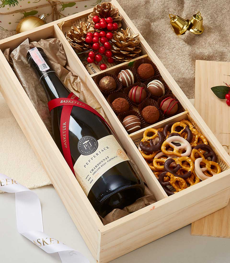 Wooden gift box with Pepperjack Chardonnay, chocolate truffles, pretzels, and festive gold pinecones