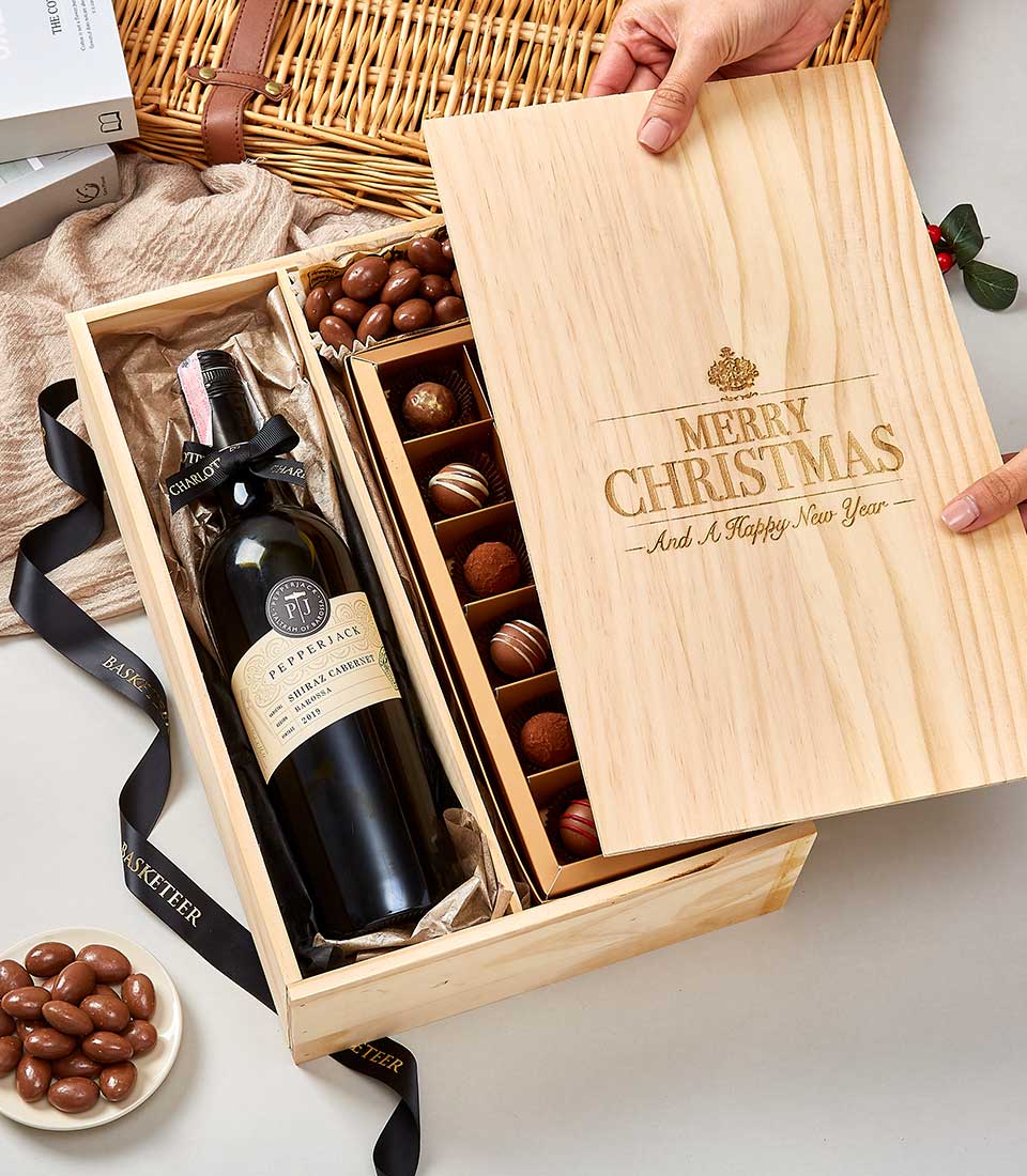 Opulent wooden gift box with Pepperjack Shiraz wine, milk chocolate almonds, and artisan chocolates, gold-engraved holiday