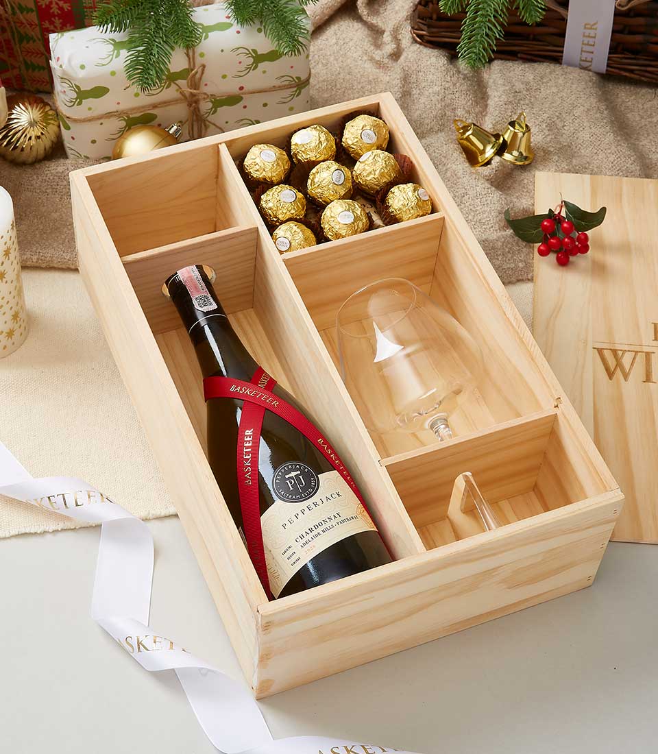 Premium wine and chocolate gift box with wooden case, wine glass, and gold-wrapped chocolates for holiday gifting