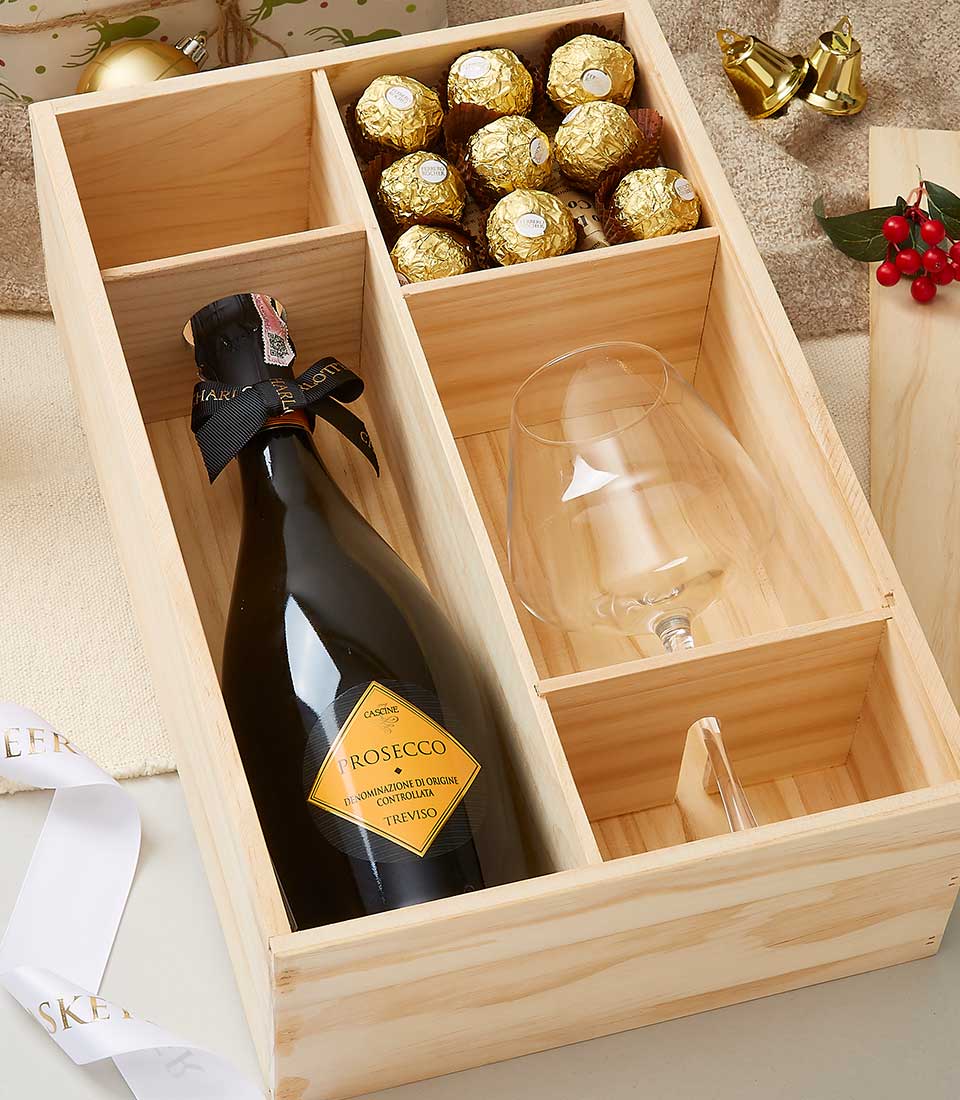 Premium Prosecco, gold chocolates, and stemless wine glass in wooden gift box with festive ribbon