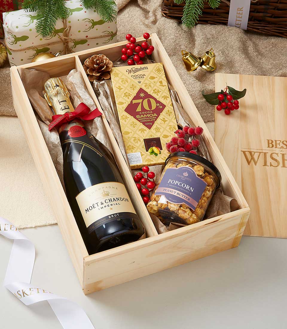 Premium wine and artisan chocolate gift box with champagne, dark chocolate bar, and gourmet popcorn in divided wooden case